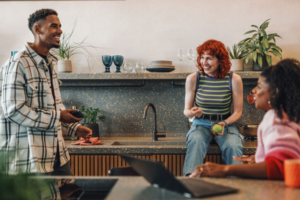 Picture of friends staying connected in a kitchen to overcome the winter blues.