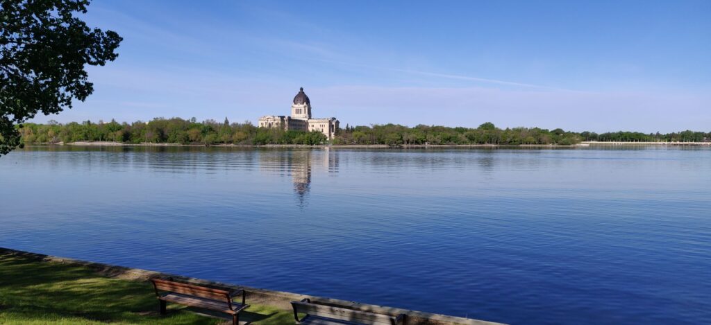 View of Wascana Lake with a large building in the background.