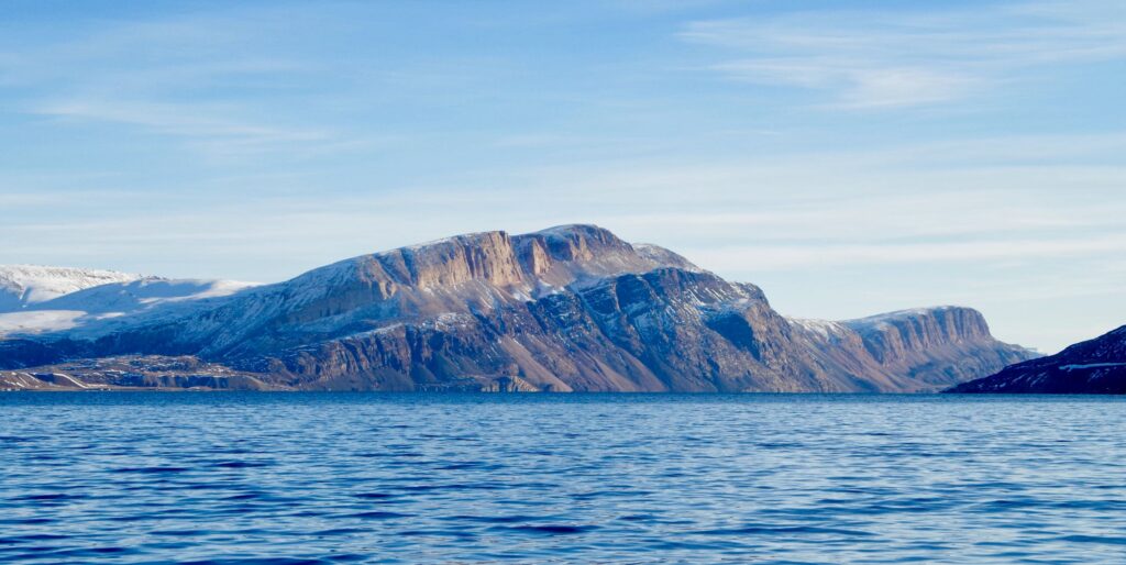 Photo of mountains across the Arctic Bay in Nunavut.