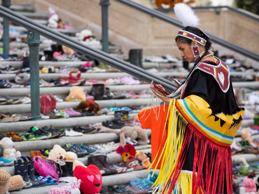 Photo of Indigenous woman remembering the suffering of Indigenous Residential Schools on Orange Shirt Day.