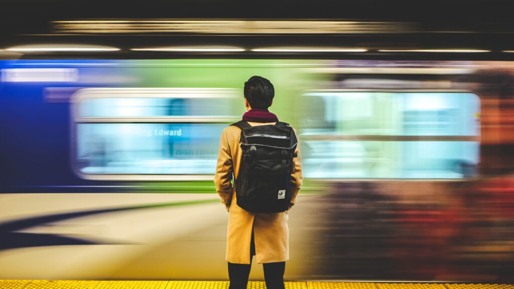 A person standing next to a SkyTrain in Vancouver.