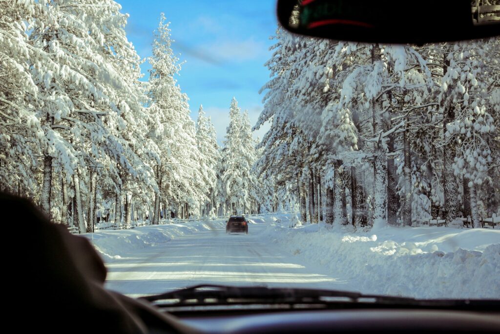 Safe driving during winter with space between cars on winter roads.