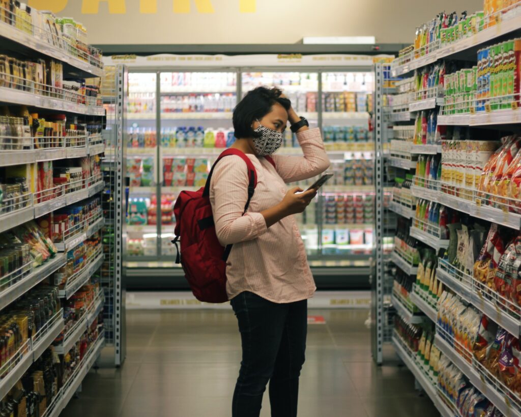 A person price matching in a grocery store.