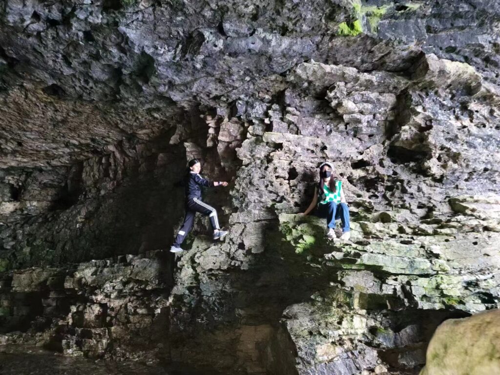 Photo of Canoo member and her child in a grotto.