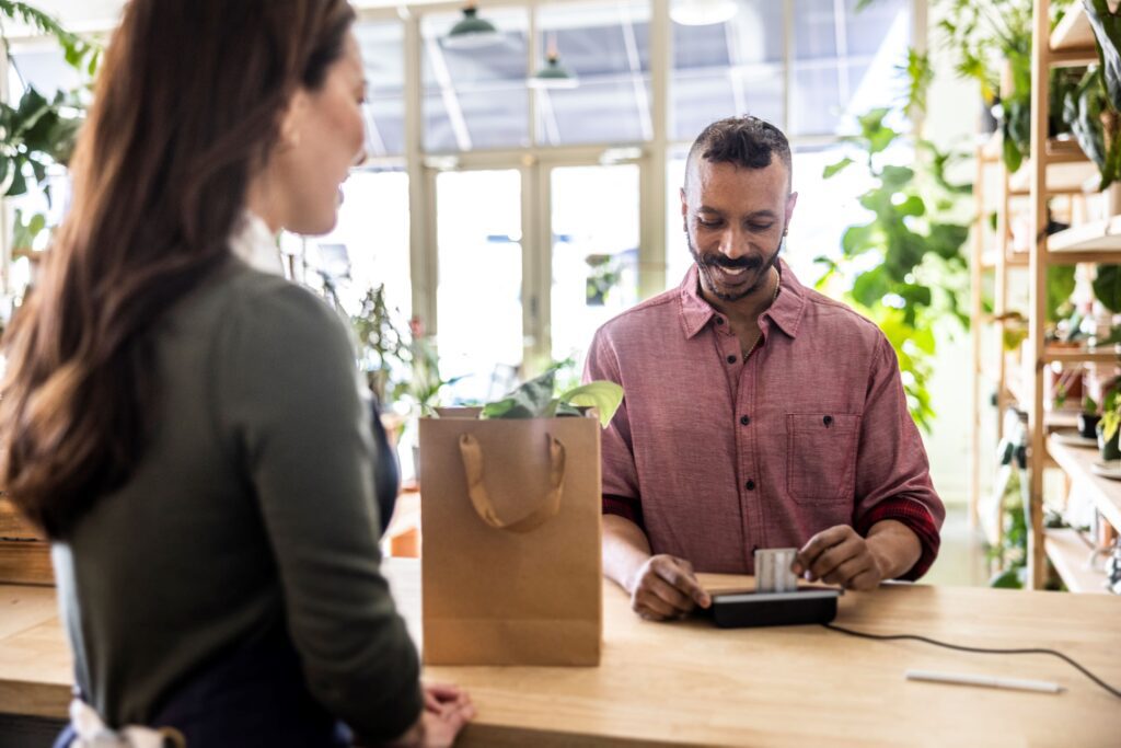 Person shopping with a CIBC credit card in a plant store.