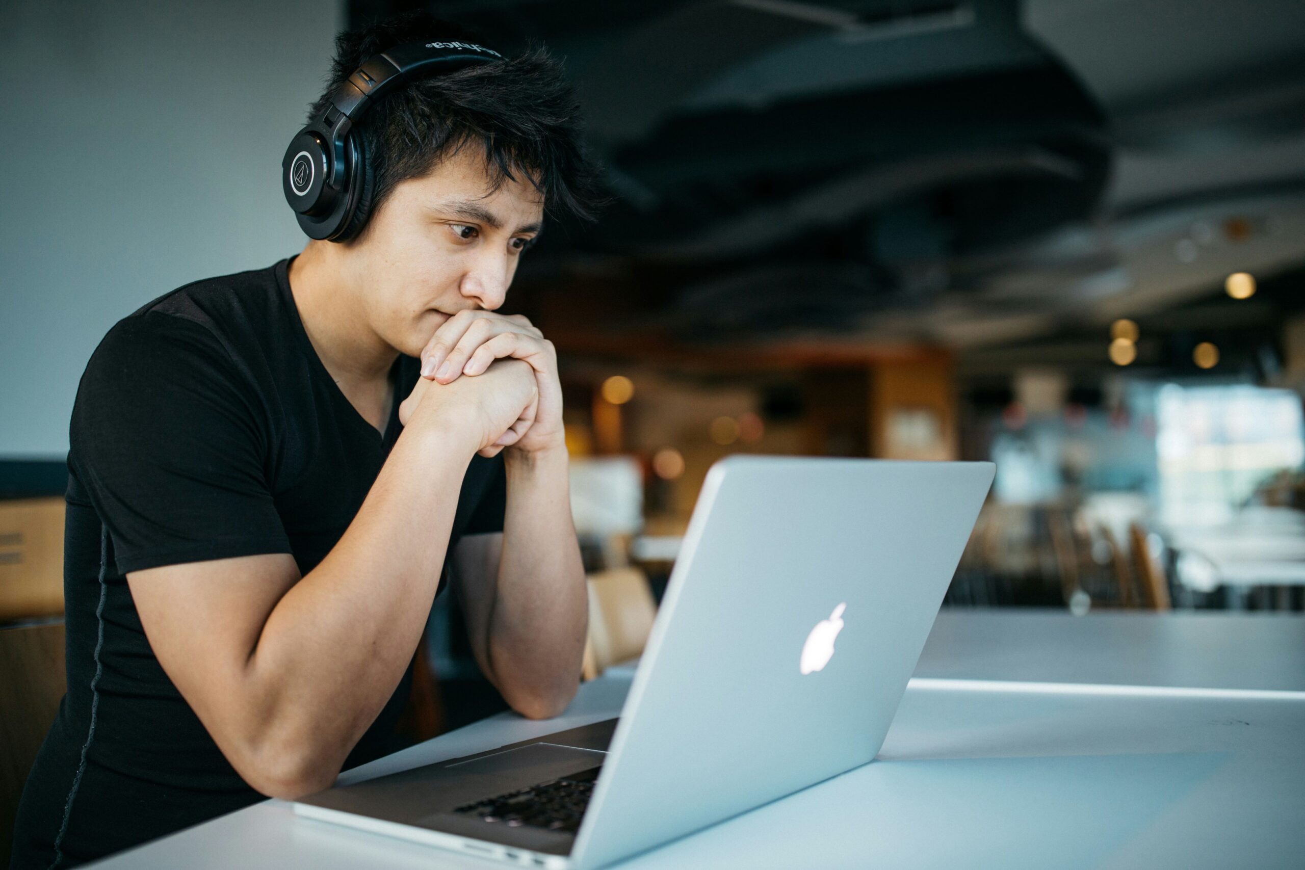 A person taking a Canadian citizenship practice test on a computer while wearing headphones.