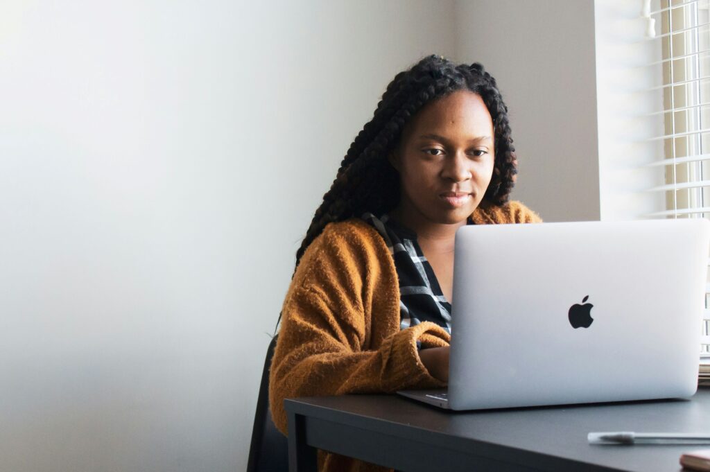 A person working on their budget on a laptop.